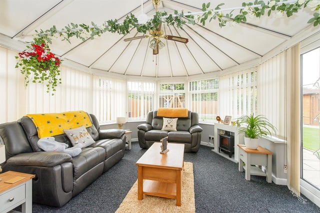 The conservatory has a ceiling fan and UPVC double glazed French doors leading out to the rear garden.