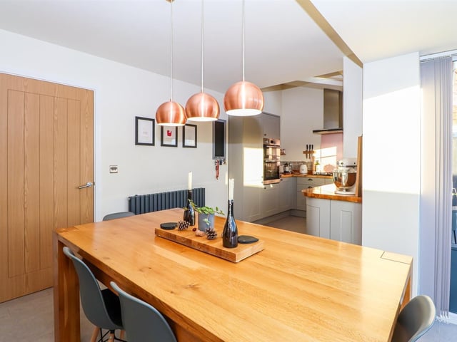 Looking from the open plan dining area through to the fitted kitchen.