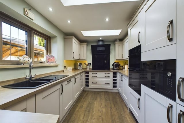 The modern kitchen is equipped with a built in electic hob/extractor, a dishwasher, an under counter freezer, a fridge-freezer and a double-oven and microwave.