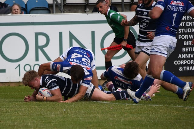 Thomas Lacans dives in to score a try.