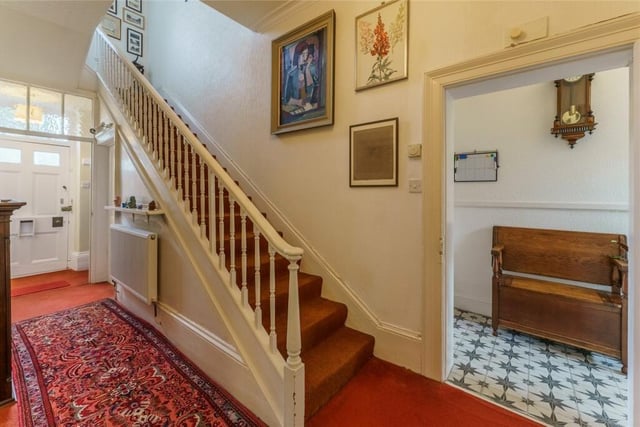 The hallway with staircase and spindle banister.