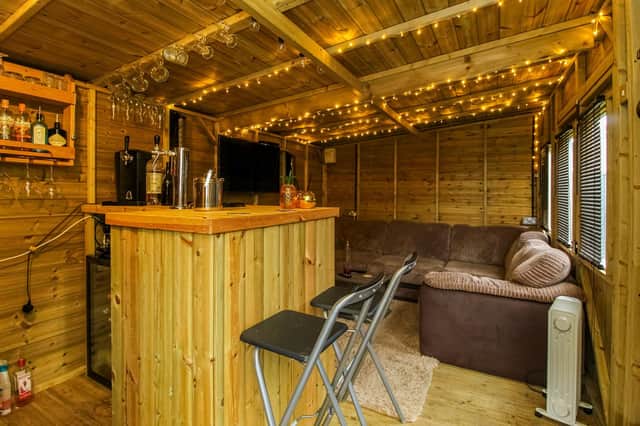 The interior of the wooden summerhouse with built-in bar.