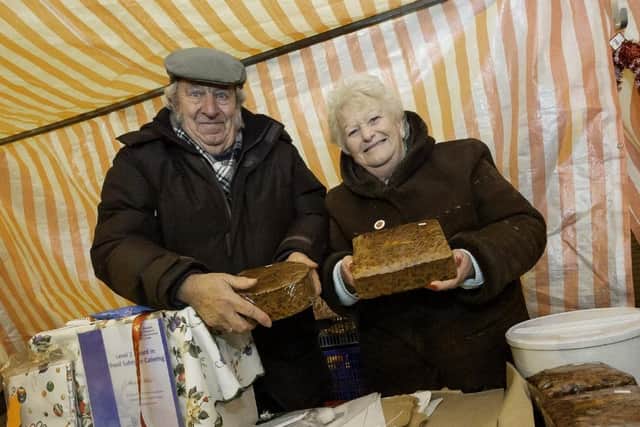 Marjorie and husband Lewis with their Christmas cake stall in 2019.