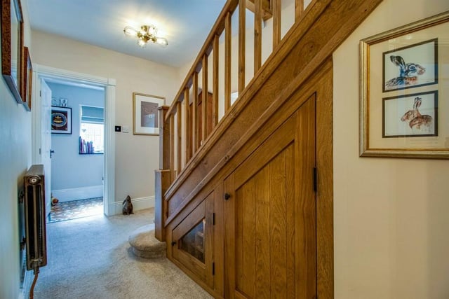 This old stone house has a formal front entrance door that leads into a central reception hall with a hand made oak staircase and guest cloakroom off to the side.