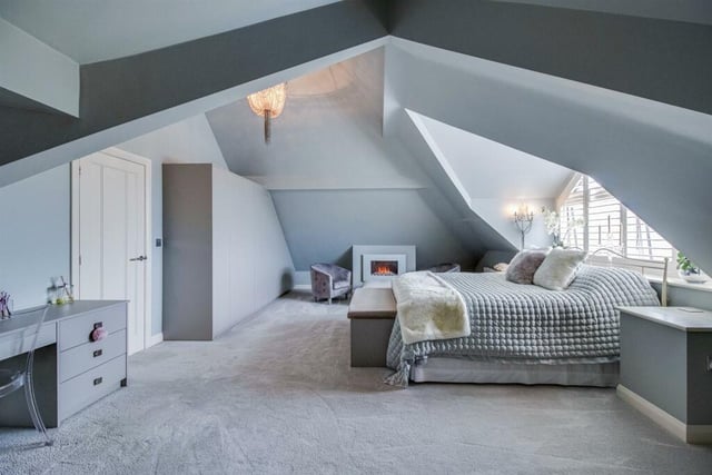 The principal bedroom has an attractive shaped and shuttered window to the side, two contemporary style central heating radiators, a feature focal point fireplace with a pebble effect electric fire and an abundance of fitted cupboards.