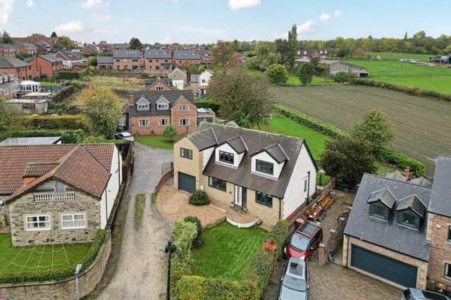An overview of the detached home in its semi-rural setting.