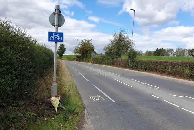 Floral tributes have been placed at the side of Wakefield Road near its junction with Common Side Lane in Featherstone