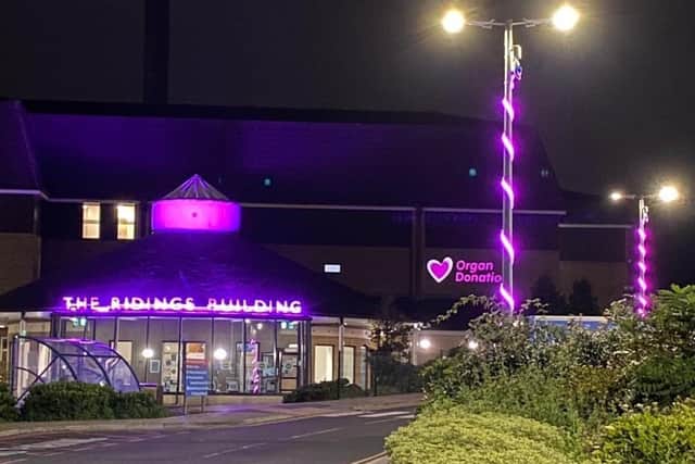 The Ridings Building at Dewsbury District Hospital lit up in pink.