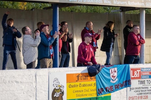 Emley supporters celebrate their side's 16th game without a defeat.