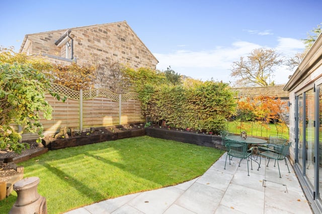 The lawned garden, with patio seating area, is attractive with a good amount of privacy.