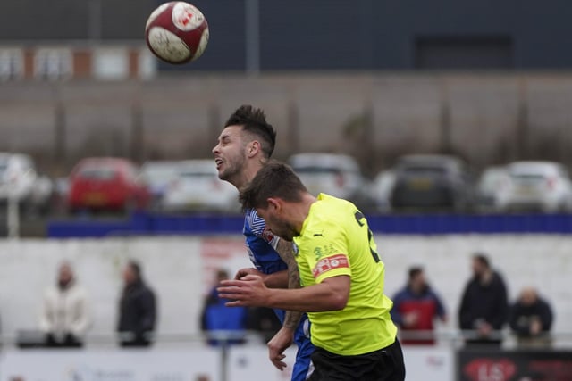 Pontefract Collieries' Ben Turner is challenged in the air.