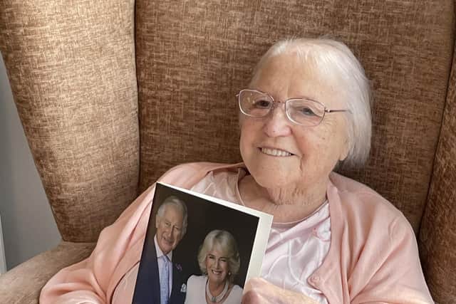 100-year-old Marjorie Brooke with her card from King Charles and Queen Consort Camilla.