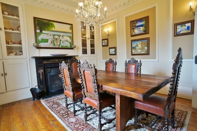 The dining room, with panelled walls and a period fireplace.