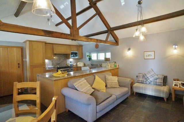 The ground floor open plan arrangement, with kitchen, dining area and comfortable seating.