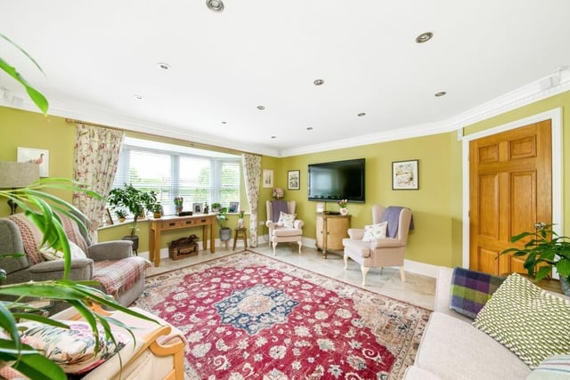An attractive bay-fronted second sitting room, or formal dining room.