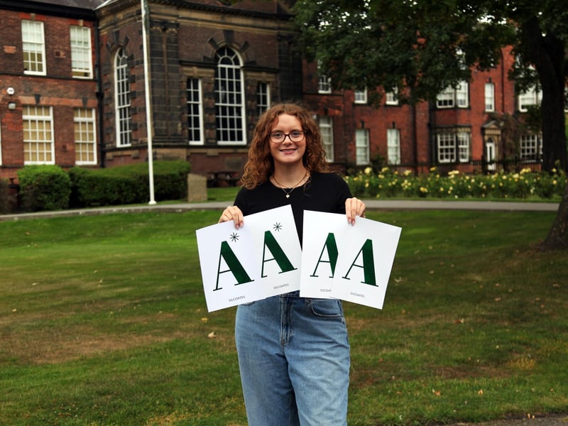 A student celebrates achieving high grades today at Silcoates School