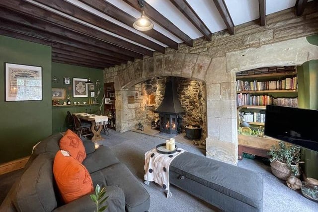 The stone arch of this Inglenook firepace with multi-fuel burner is thought to be from Pontefract Castle.