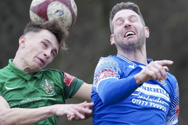 Pontefract Collieries striker Gavin Allott challenges for a high ball.
