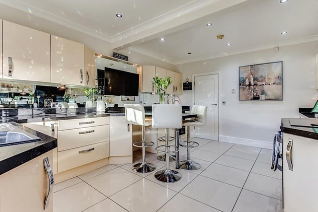 The stunning, high gloss breakfast kitchen, that has a range of integrated appliances.