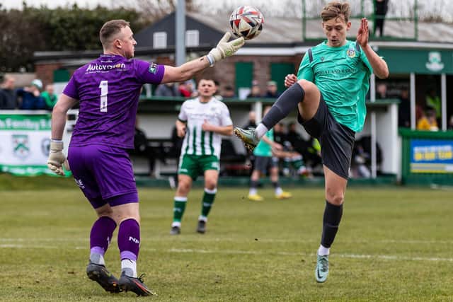 Frickley Athletic's Lloyd Smith is denied by North Ferriby goalkeeper Lewis Exall. Picture: John Hobson