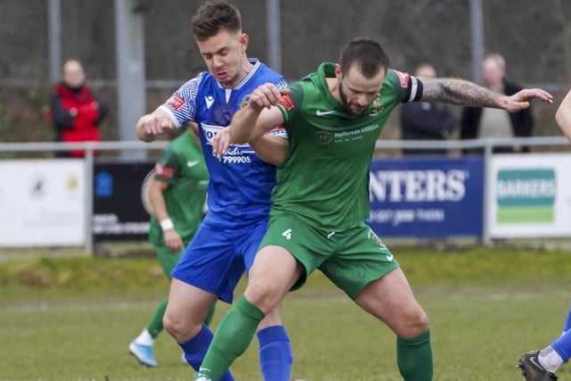 Pontefract Collieries and Brighouse Town tangle in a bid to win possession.