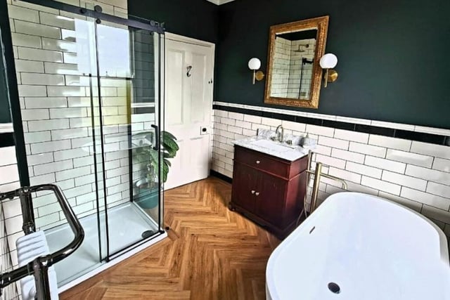 A super stylish bathroom with suite containing both bath and walk-in shower.