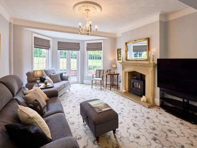The lounge boasts two bay windows and a third front window creating a triple aspect. French doors set within the rear bay window open out to the garden, offering peaceful green views all year round.