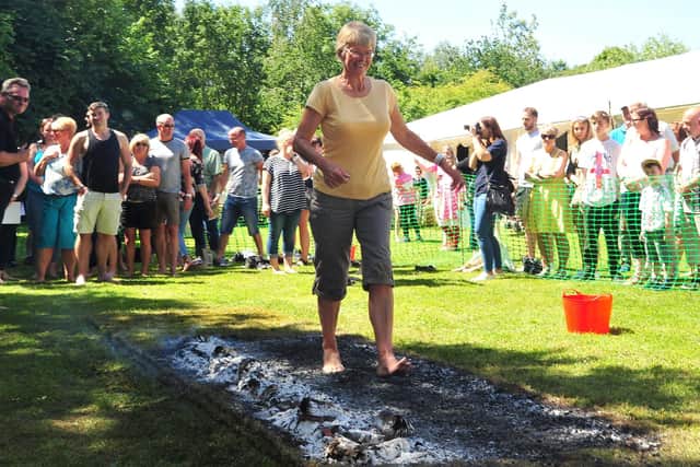 Brave volunteers are firewalking across hot coals to raise money for the charity, Cash for Kids.