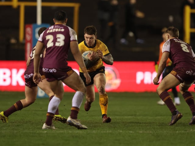 Castleford Tigers' Jordan Lane in action with Huddersfield Giants' Chris Patolo.