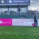 WDH Care Link staff alongside their pitch side boards that will be in place at Castleford Tigers, Featherstone Rovers and Wakefield Trinity (pictured)