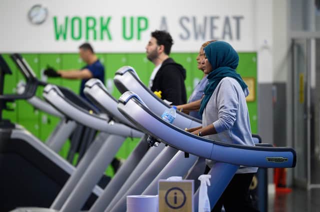 People exercising at a gym. (Photo by Leon Neal/Getty Images)