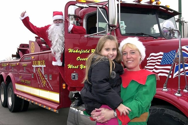 Santa visits Asda store in Durkar in 2004. Seven year old Kate Bowen is pictured with Santa and one of his little elves.