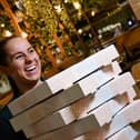 Paige Clarke, Duty Manager of ASK Italian at Xscape Yorkshire with a stack of pizzas