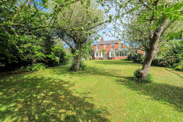 Lovely lawned gardens stretch to the south from the house, with mature trees and shrubs.