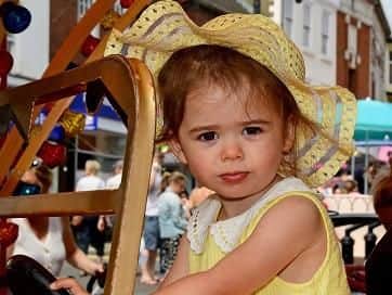 Little Lottie has fun on one of the rides.