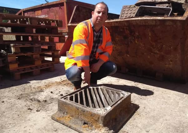 Coun Matthew Morley with one of the old-style grates that are being taken by thieves.
