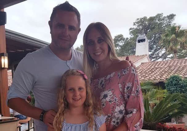 Darcey with her parents Alex and Gareth.