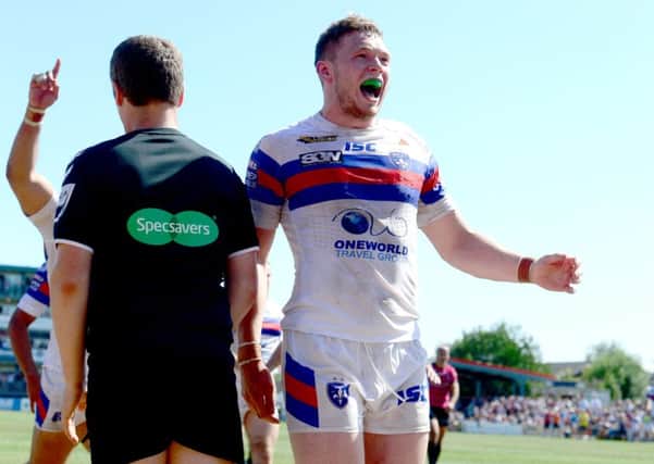 James Batchelor, of Wakefield Trinity, celebrates after scoring a try at the end of the first half.