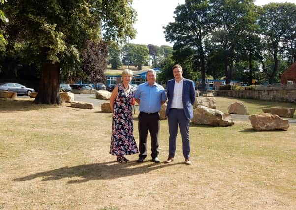 Councillors Celia Loughran, David Jones and George Ayre are hoping to put right the boulders on Carleton Green.