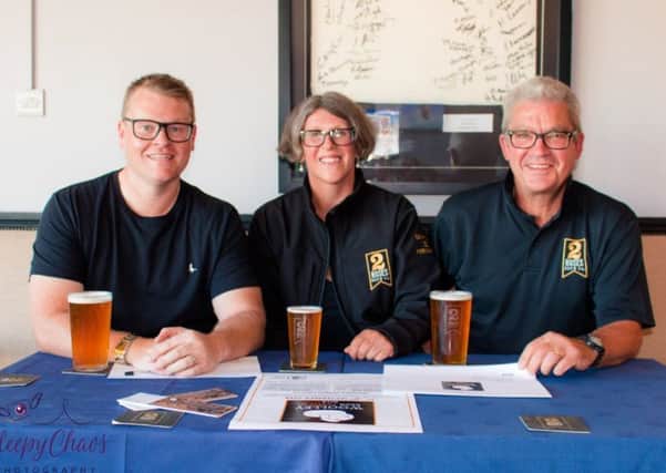 CHEERS: Festival chairman Dan Jennings, left, with Alison Lockwood and James Taylor of Two Roses Brew Co.