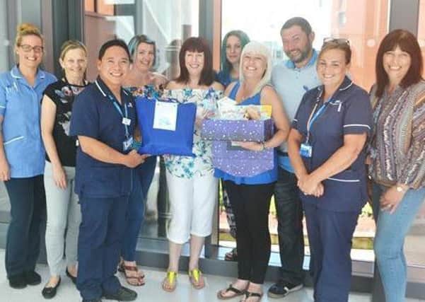 Jamie's mum, Donna Howden (pictured centre), with family members and staff from Pinderfields ICU.