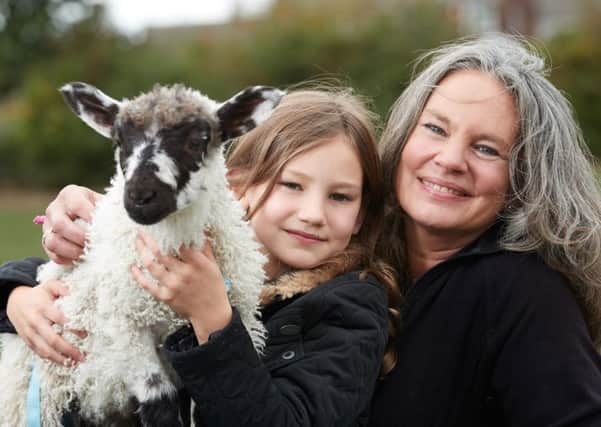 Sarah Hughes, eight, is the best of friends with Luke the lamb.