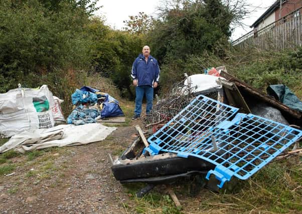 Slap in the face:  Coun Martyn Ward with dumped rubbish at Harewood Lane in Upton.