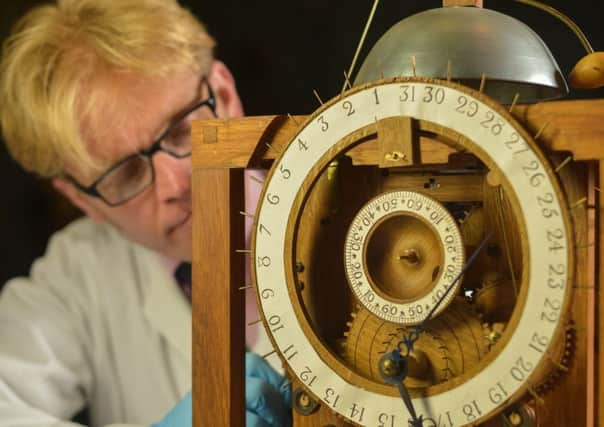 Expert conservator Matthew Read repairs a replica of the 18th Harrison Clock, which helped its original maker determine longitude to win a prize equivalent to Â£3m today.