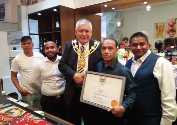 Currying favour: Kamal Amiah with Mayor of Wakefield Stuart Heptinstall, and staff.