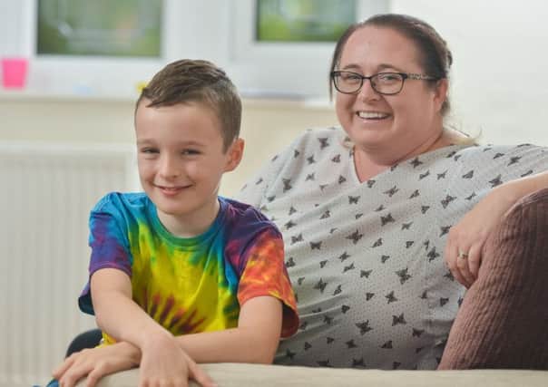 All smiles: Connor and mum Michaela, who say life has been great since his pioneering operation.