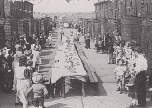 Well-stocked tables for the VE Day celebrations in Smith Street backs at Fryston is the image for May 2019.