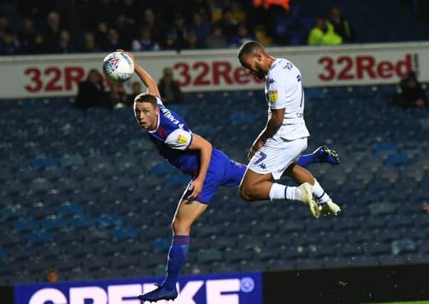 Kemar Roofe beats former teammate Matthew Pennington to head in the opening goal for Leeds United against Ipswich.  Picture: Jonathan Gawthorpe
