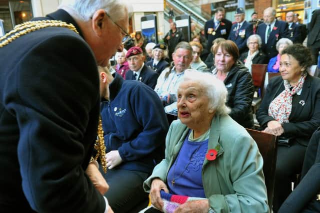 251018  The Lord Mayor of Leeds Clly  Graham Latty  presents   Winnie                ex WAAF with  the first poppy  at the launch of the Leeds Poppy appeal at the Light in  Leeds
