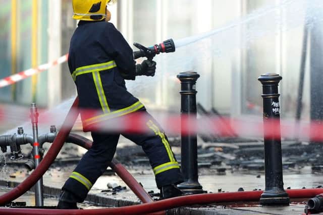 Embargoed to 0001 Tuesday March 27 Undated file photo of a firefighters tackling a blaze. Arsonists could face tougher punishments if their crimes result in damage to listed buildings or a major emergency response under new sentencing plans.